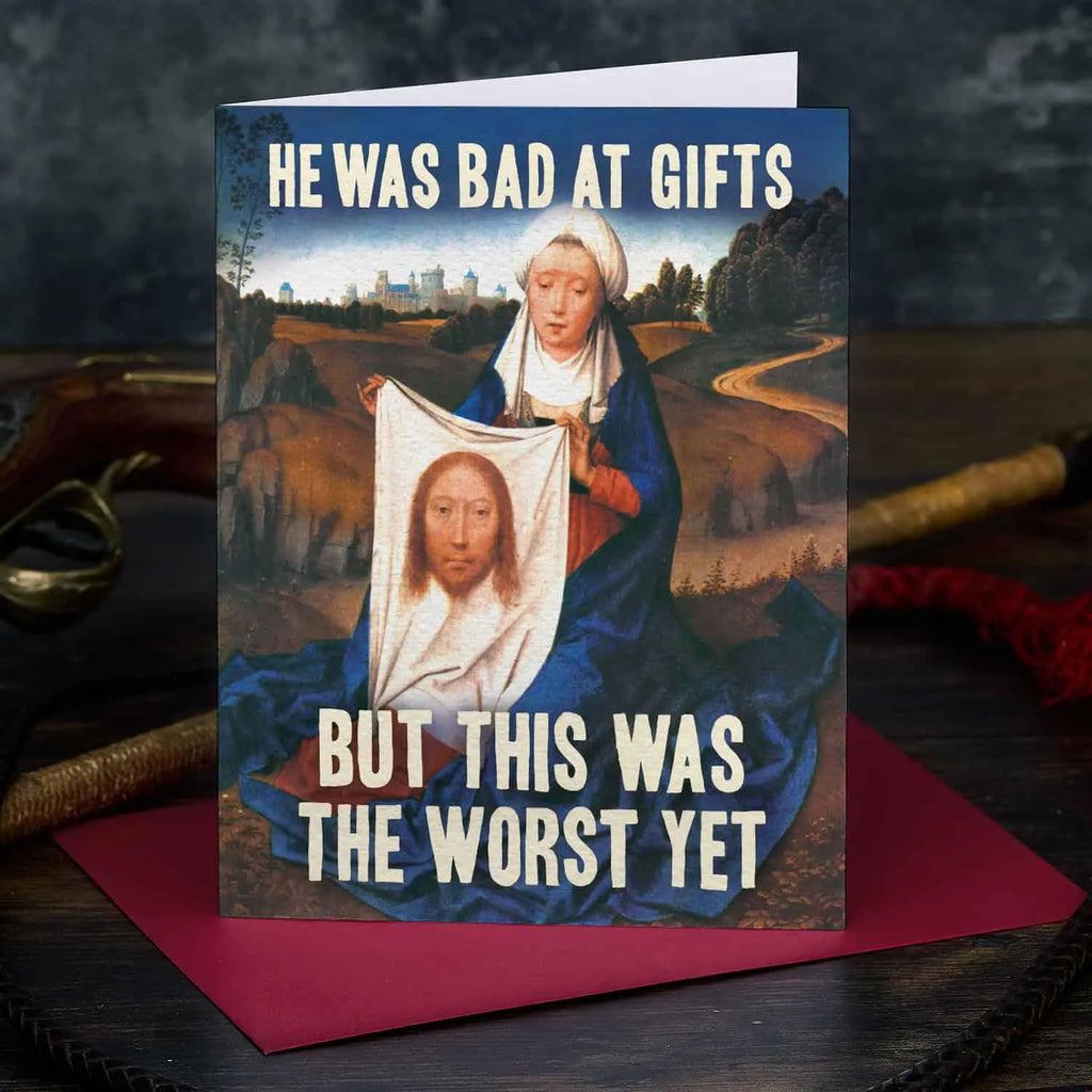 Card with classical painting of a woman holding a portrait, text 'He was bad at gifts but this was the worst yet', on a dark background.