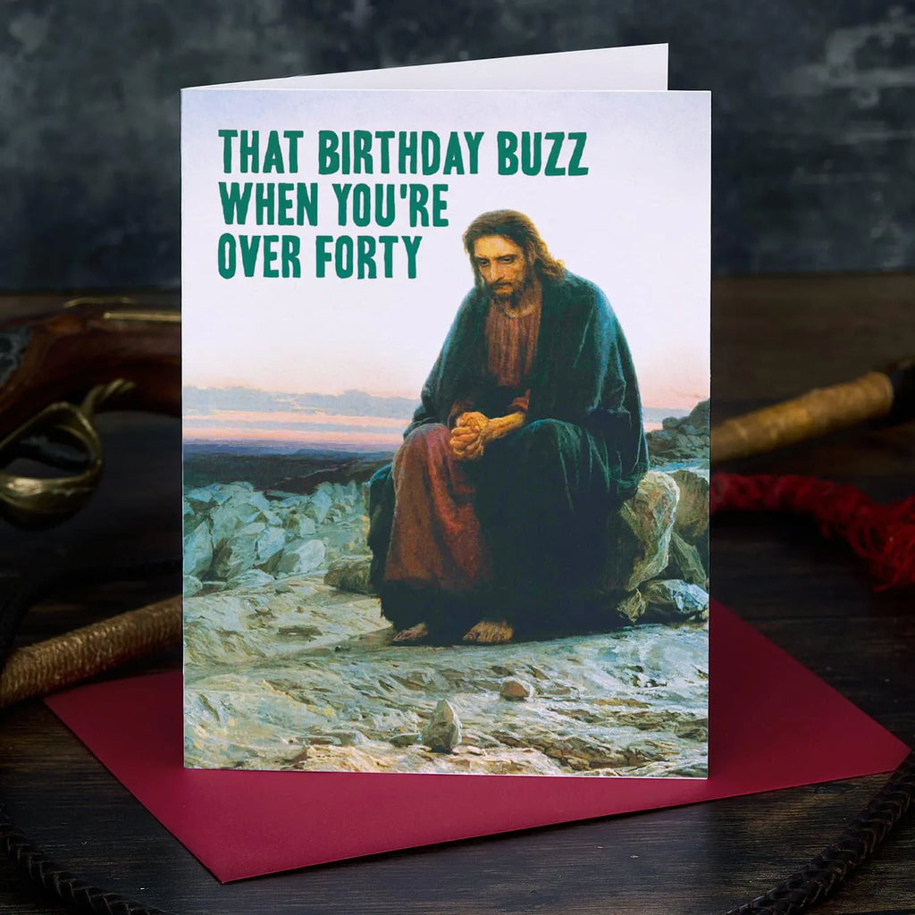 Card with a religious figure sitting on rocks and text 'THAT BIRTHDAY BUZZ WHEN YOU'RE OVER FORTY' on a dark background.