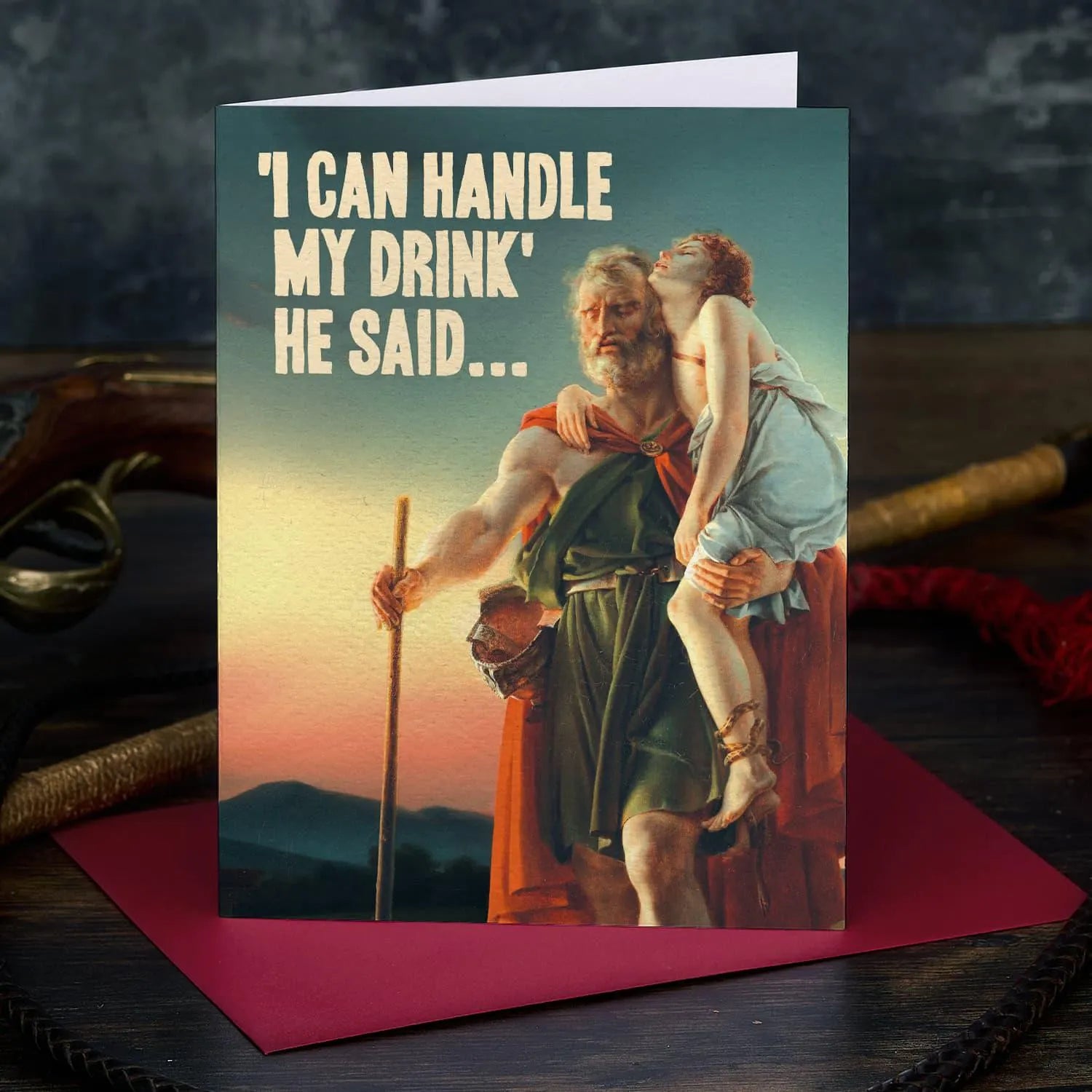 Card with classical painting of a man holding a woman, text 'I can handle my drink he said', on a dark background.