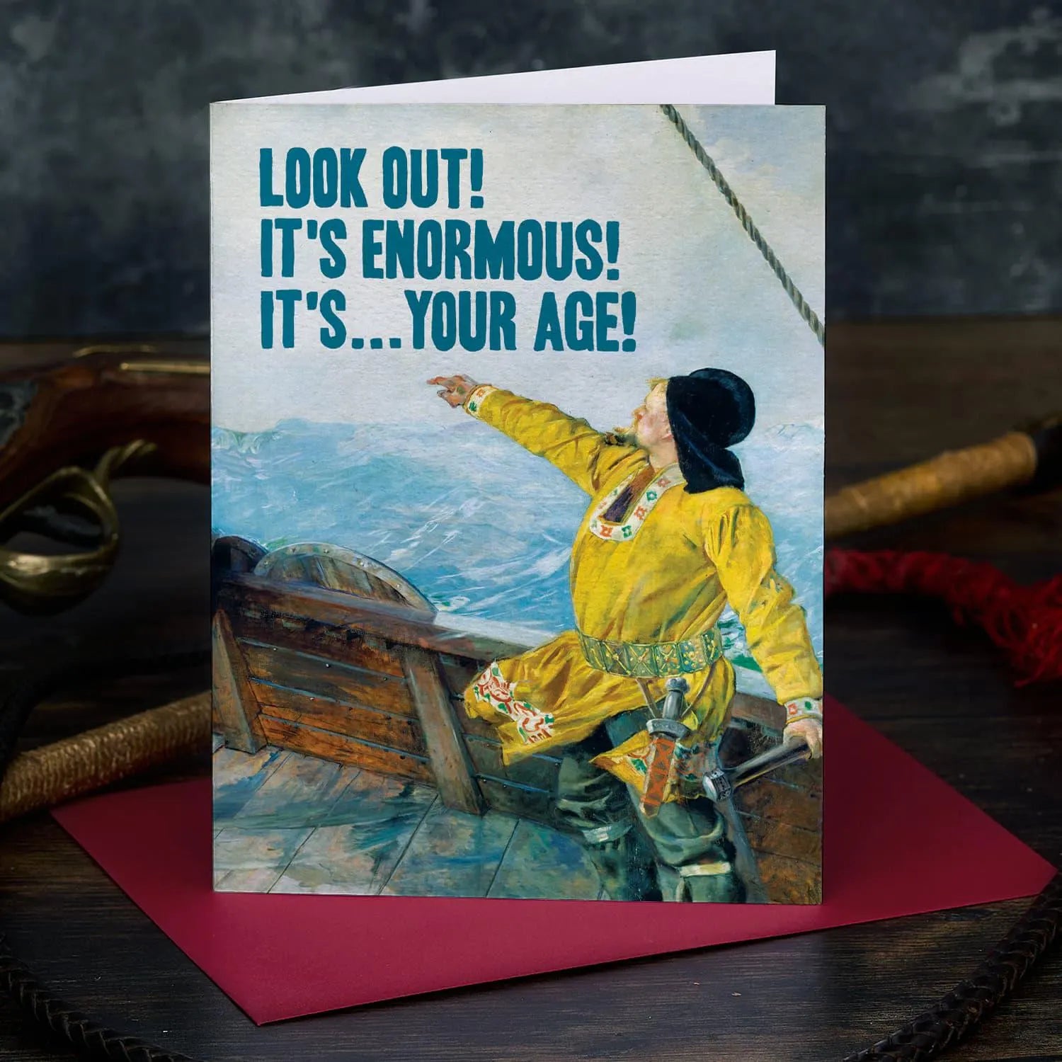 Birthday card with a person in a yellow coat on a ship and humorous text.