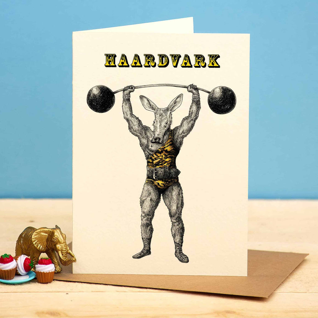 Greeting card with a graphic of a muscular animal lifting weights, labeled 'HAARDVARK', on a blue background.