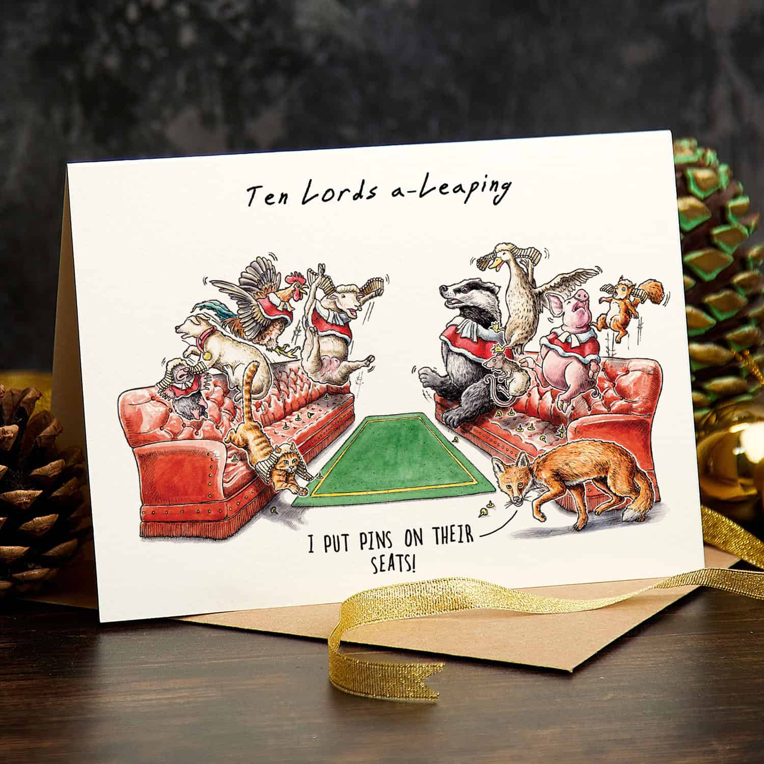 Card with festive illustration of animals playing 'Ten Lords a-Leaping' game, surrounded by Christmas decor.