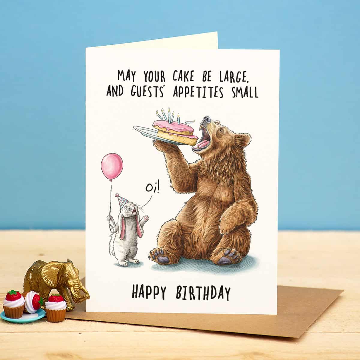 Birthday card with bear and rabbit illustration and humorous text on a blue background