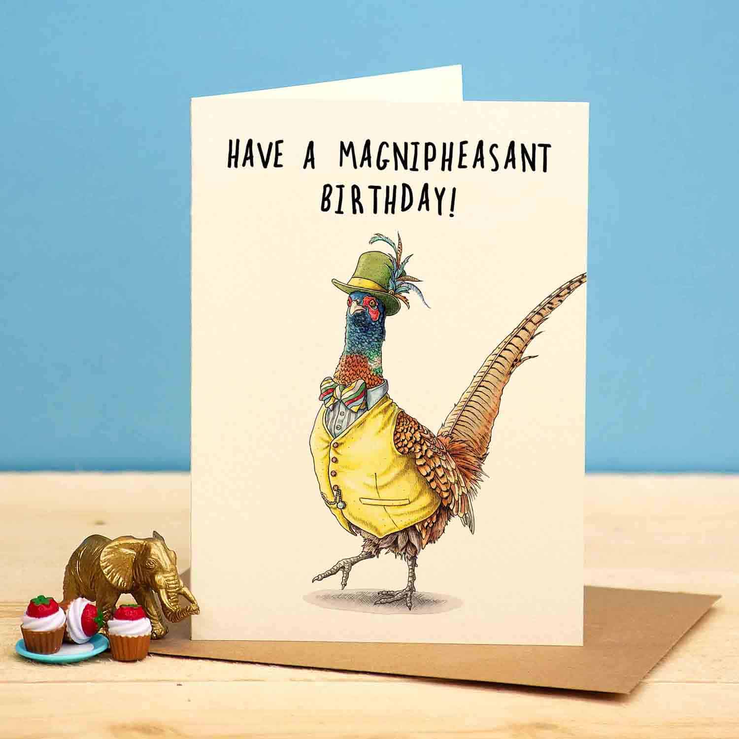 Birthday card with a magnipheasant illustration and humorous text on a blue background.