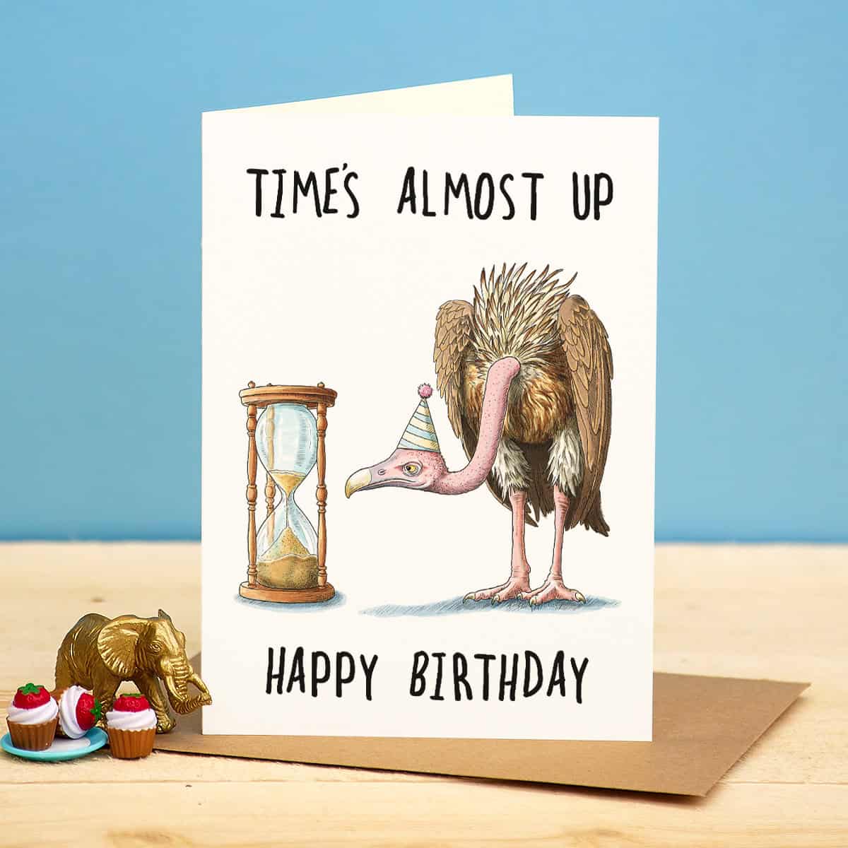 Birthday card with a flamingo and hourglass illustration on a blue background