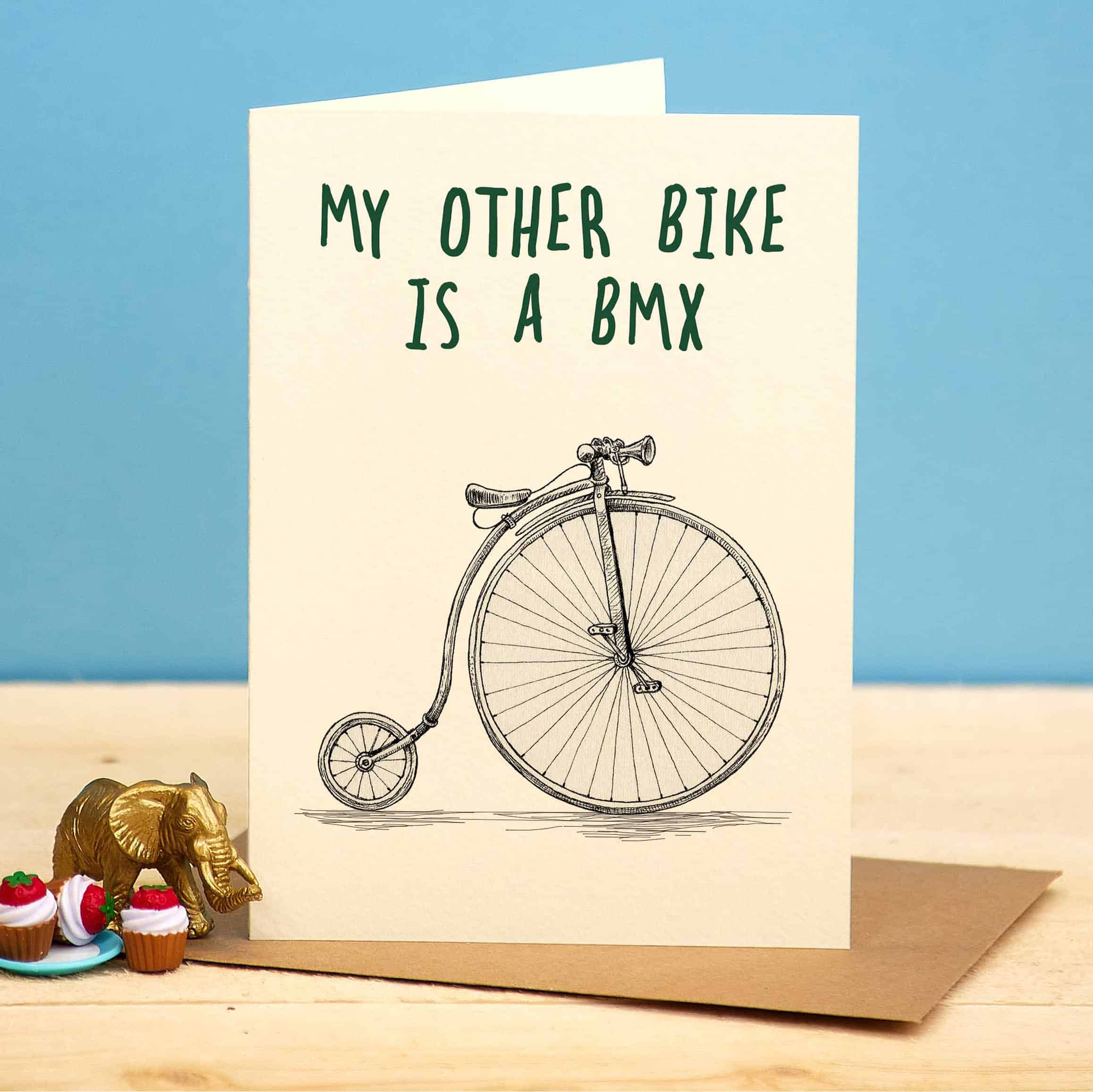Card with vintage bicycle illustration and text 'My other bike is a BMX' on a blue background