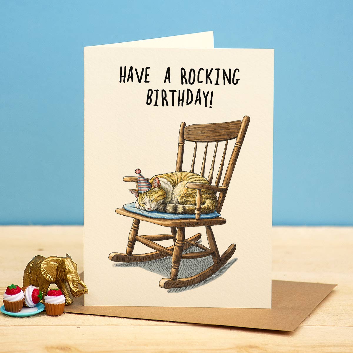 Birthday card with cats in a rocking chair and 'Have a rocking birthday!' text on a blue background.