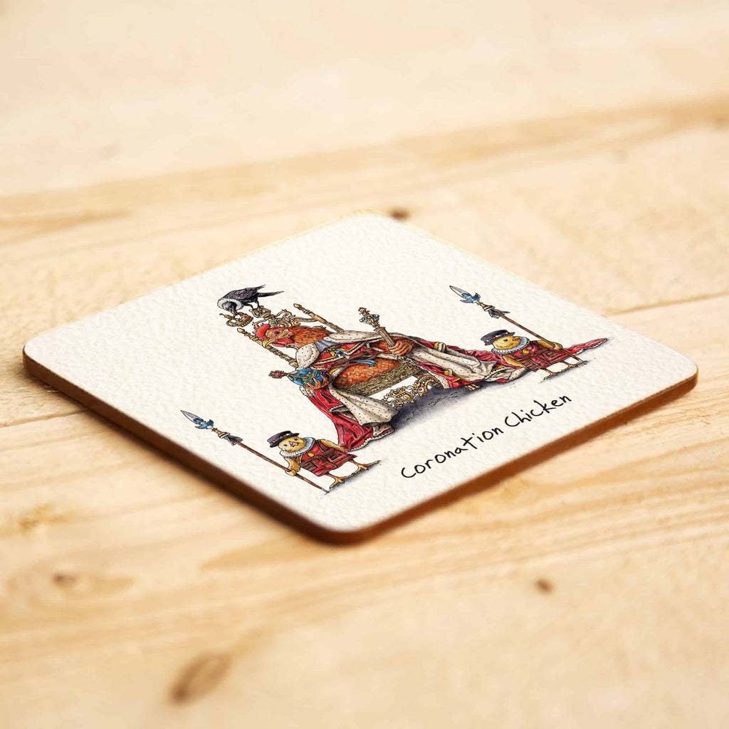 Coaster with a design of a coronation  chicken scene on a wooden surface