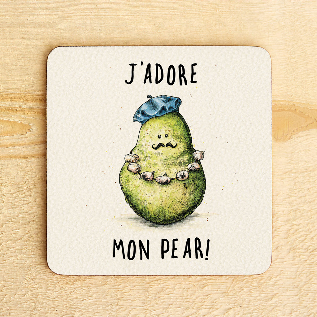 Coaster with a pear illustration wearing a hat and necklace, text 'J'adore mon pear!' on a wooden surface.