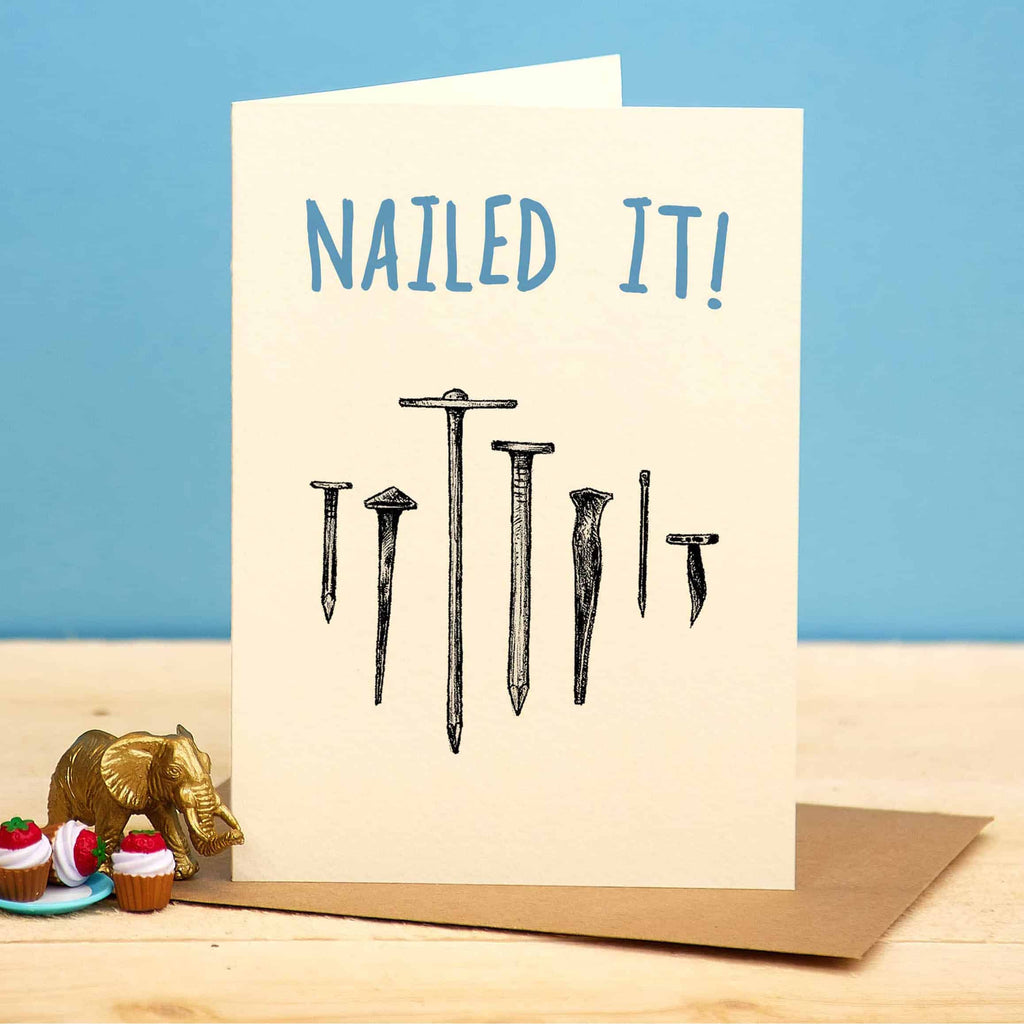 Greeting card with nails and 'NAILED IT!' text on a blue background
