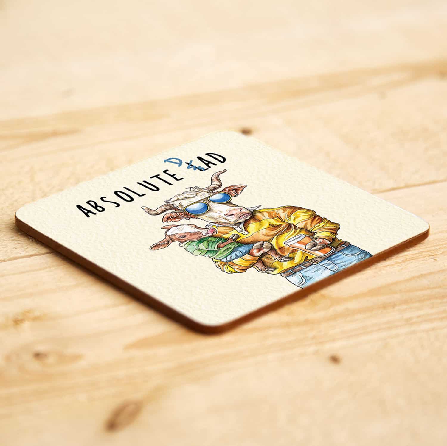 Coaster with cartoon character and 'Absolute Dad' text on a wooden surface