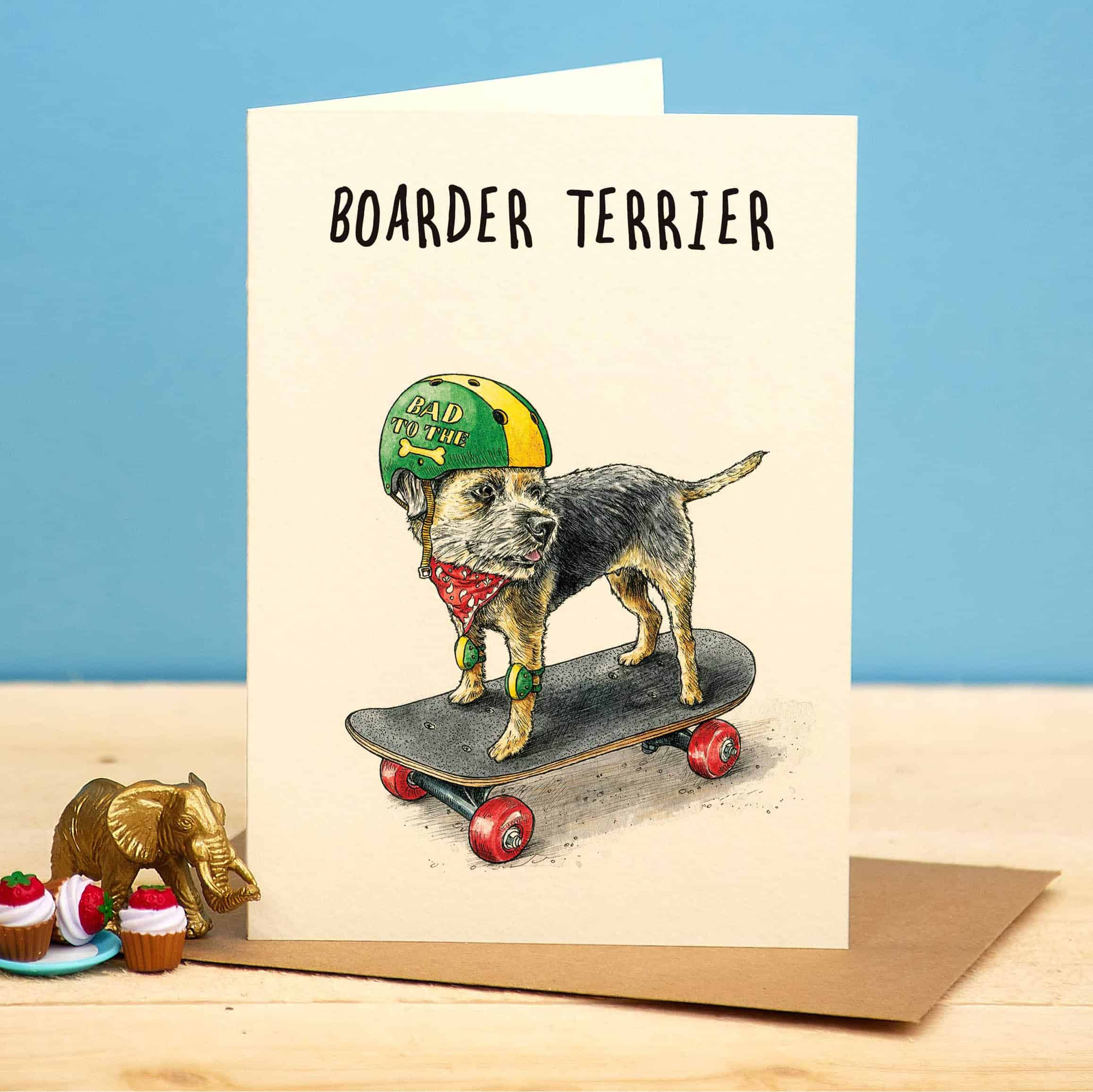 Greeting card with a dog on a skateboard wearing a helmet and bandana, set against a blue background.