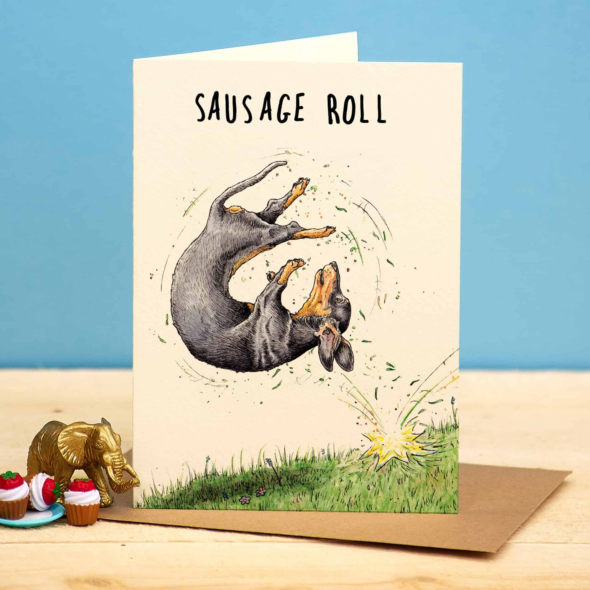 Greeting card with a dachshund illustration and 'Sausage Roll' text on a beige background.