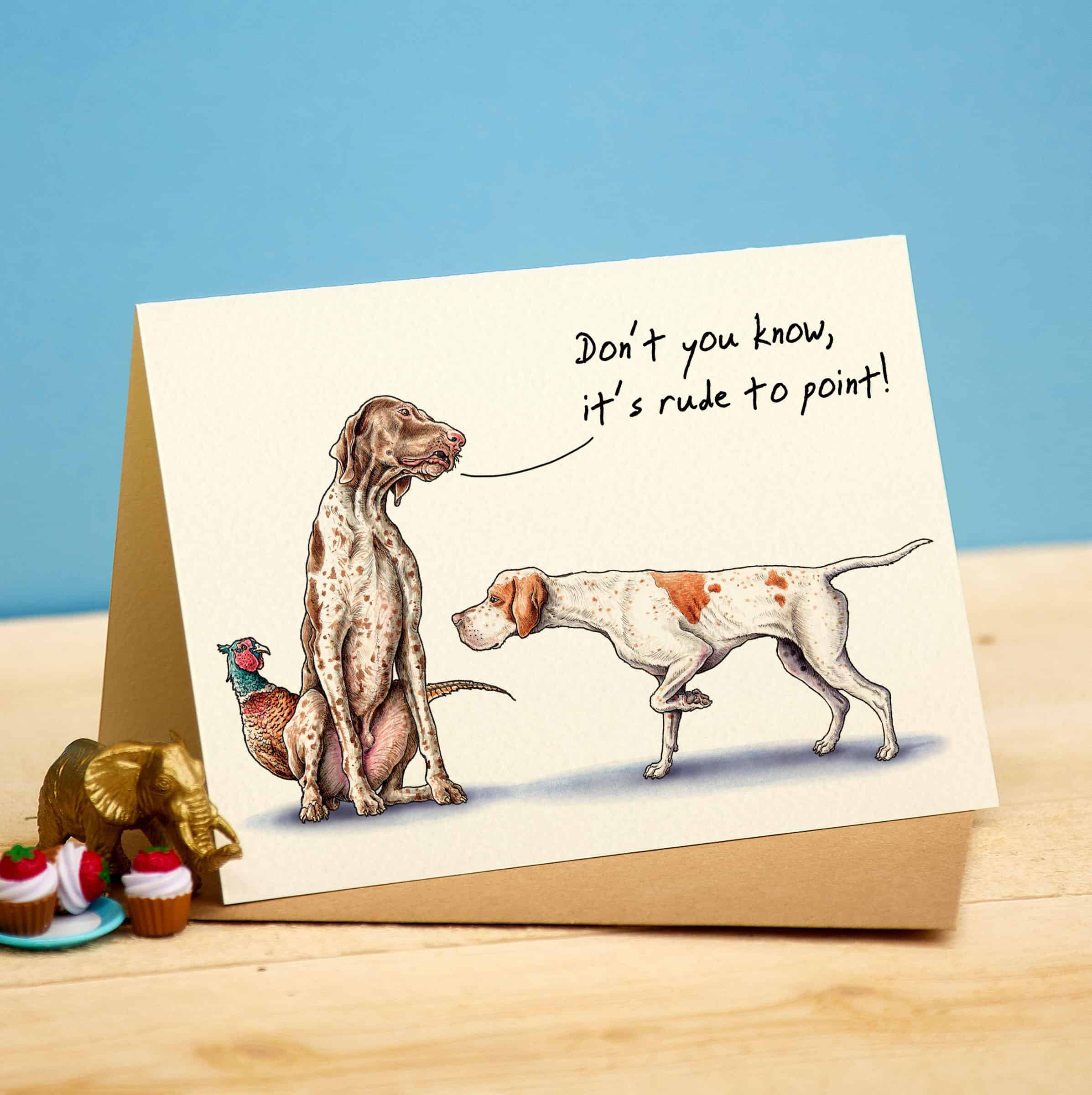 Card with illustration of two dogs and a message on a wooden surface with a blue background