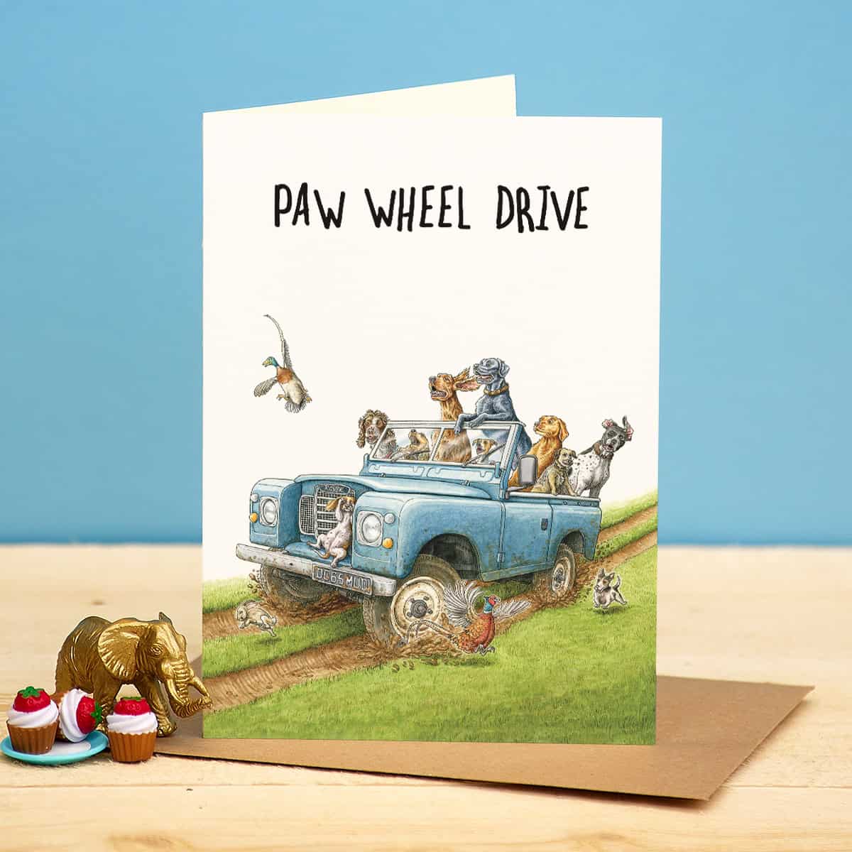 Card with illustration of a truck and animals on a blue background