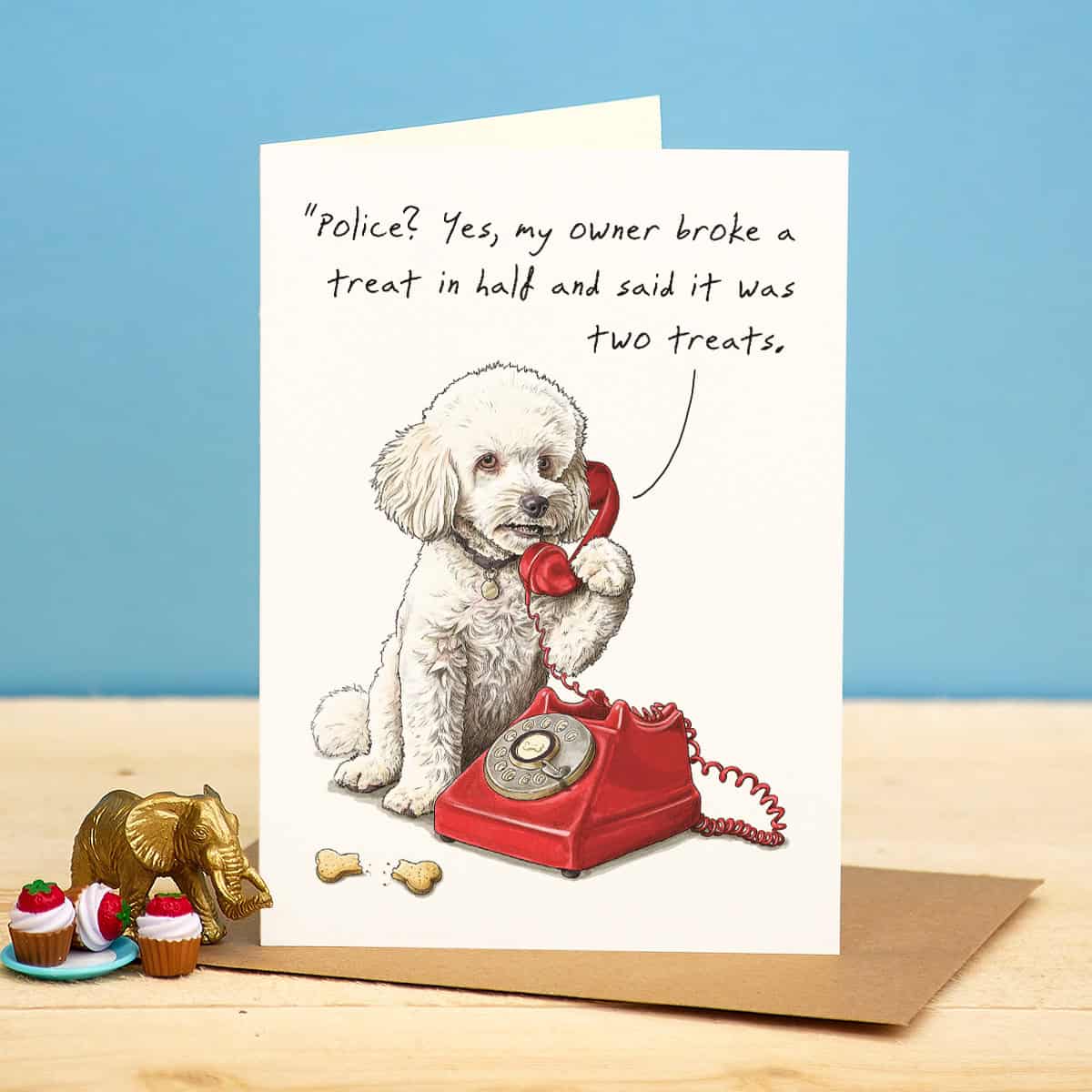 Card with a dog on a red phone, text about a treat, and a blue background
