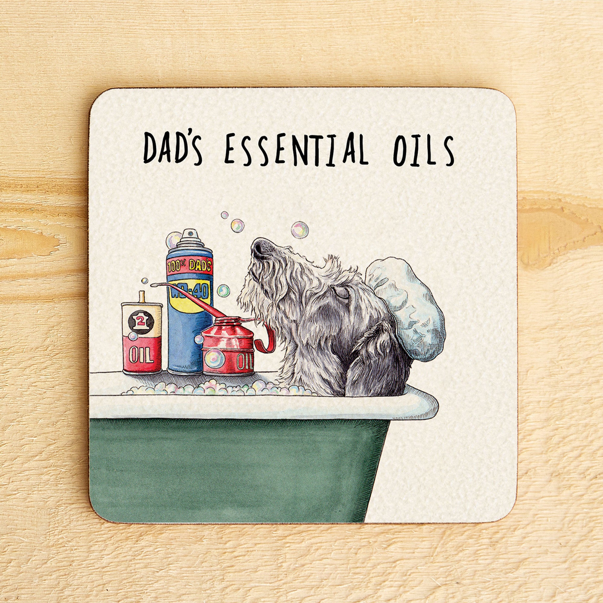 Coaster with a dog taking a bath and 'Dad's Essential Oils' text on a wooden surface
