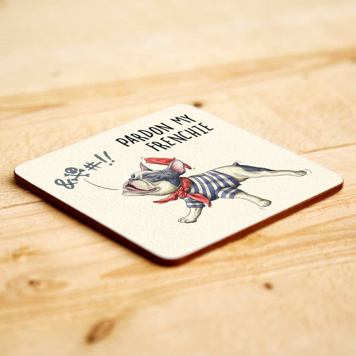 Coaster with a French bulldog and text on a wooden surface
