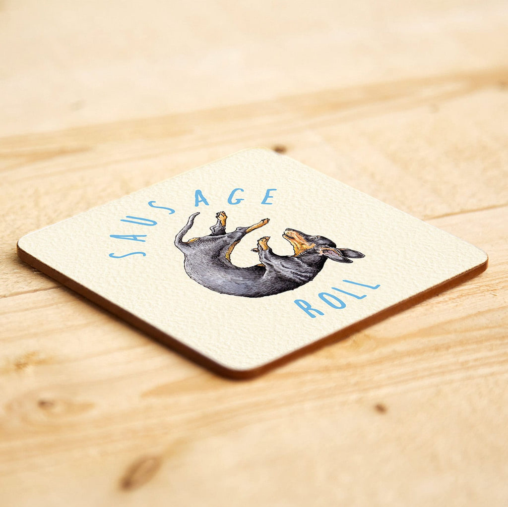 Coaster with a sausage dog illustration and 'Sausage Roll' text on a wooden surface