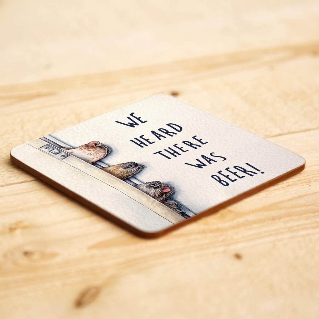 Coaster with dogs and text 'We heard there was beer!' on a wooden surface