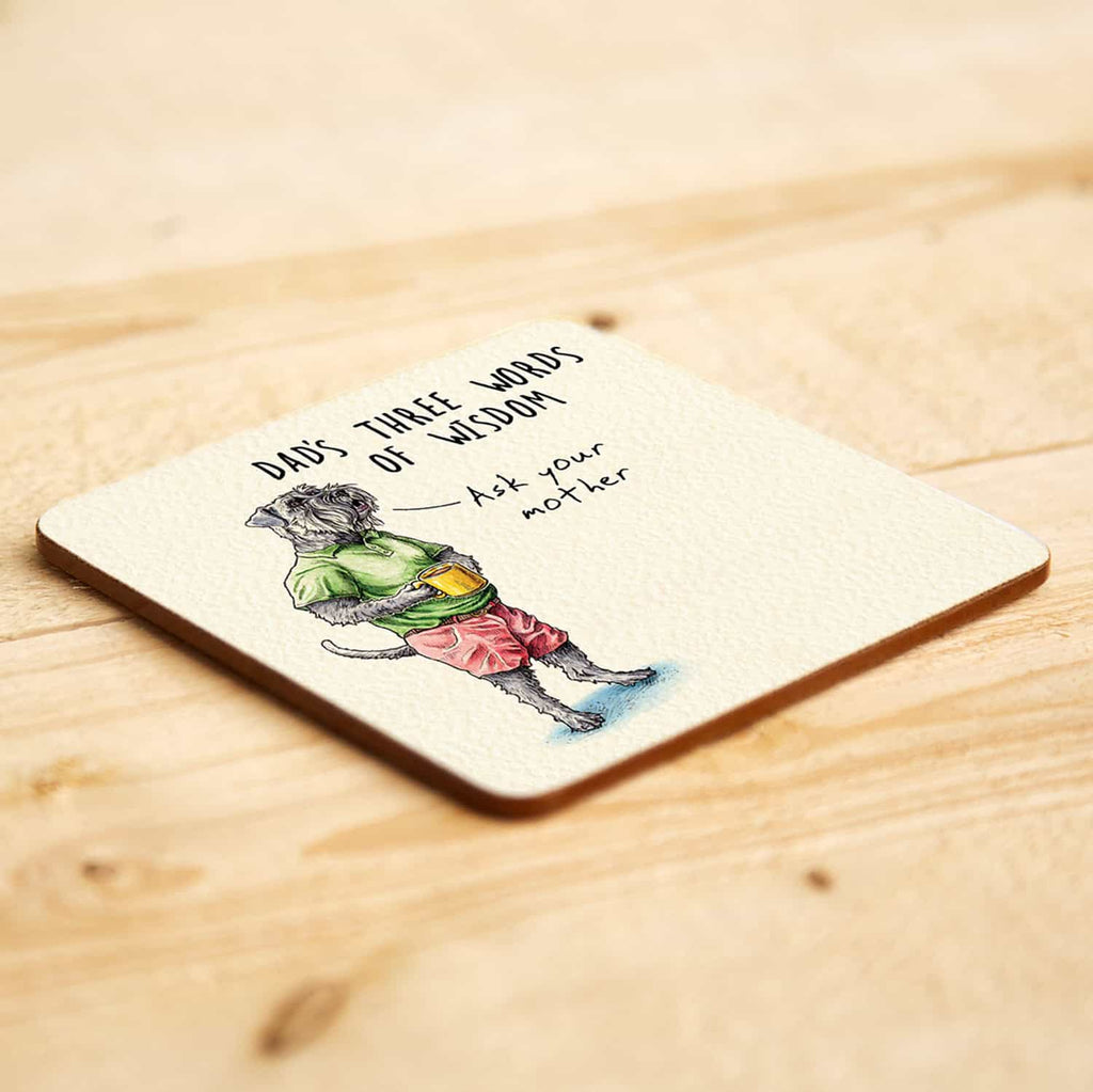 Coaster with a dog illustration and humorous text on a wooden surface