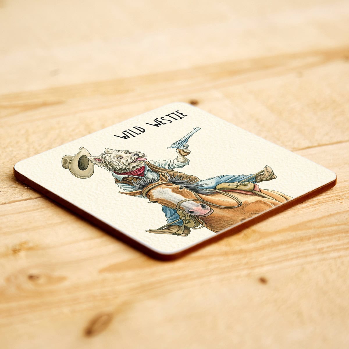 Coaster with a cowboy Westie dog on horseback design and 'Wild West' text on a wooden surface