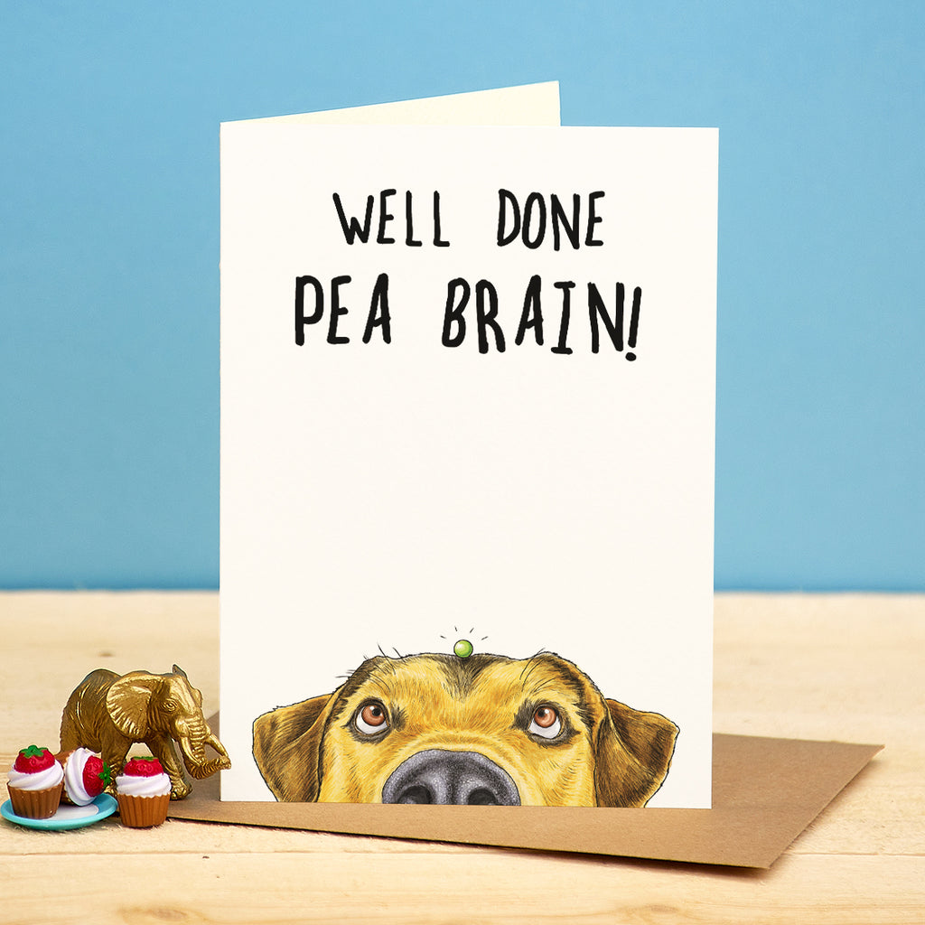 Card with a dog illustration and 'Well Done Pea Brain!' text on a blue background