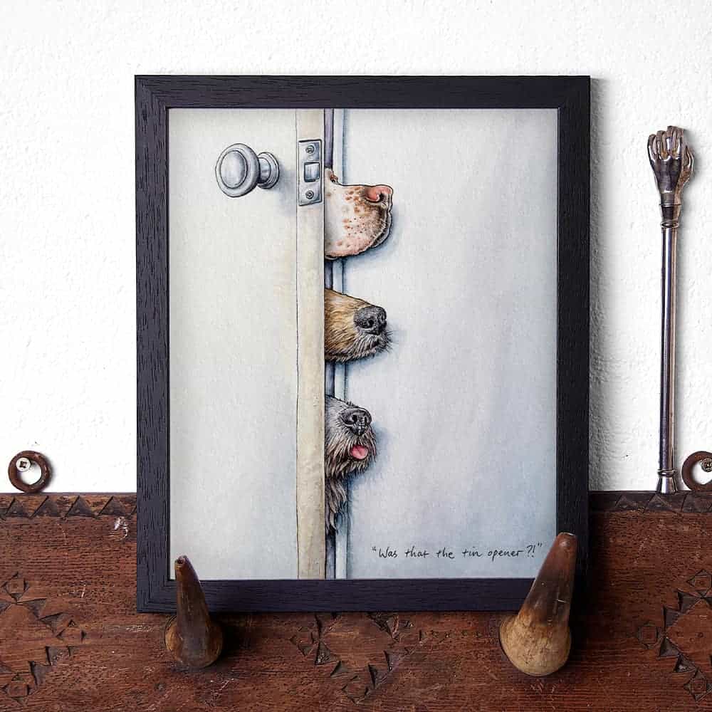 Artwork of three dogs peeking over a door handle on a wooden surface.