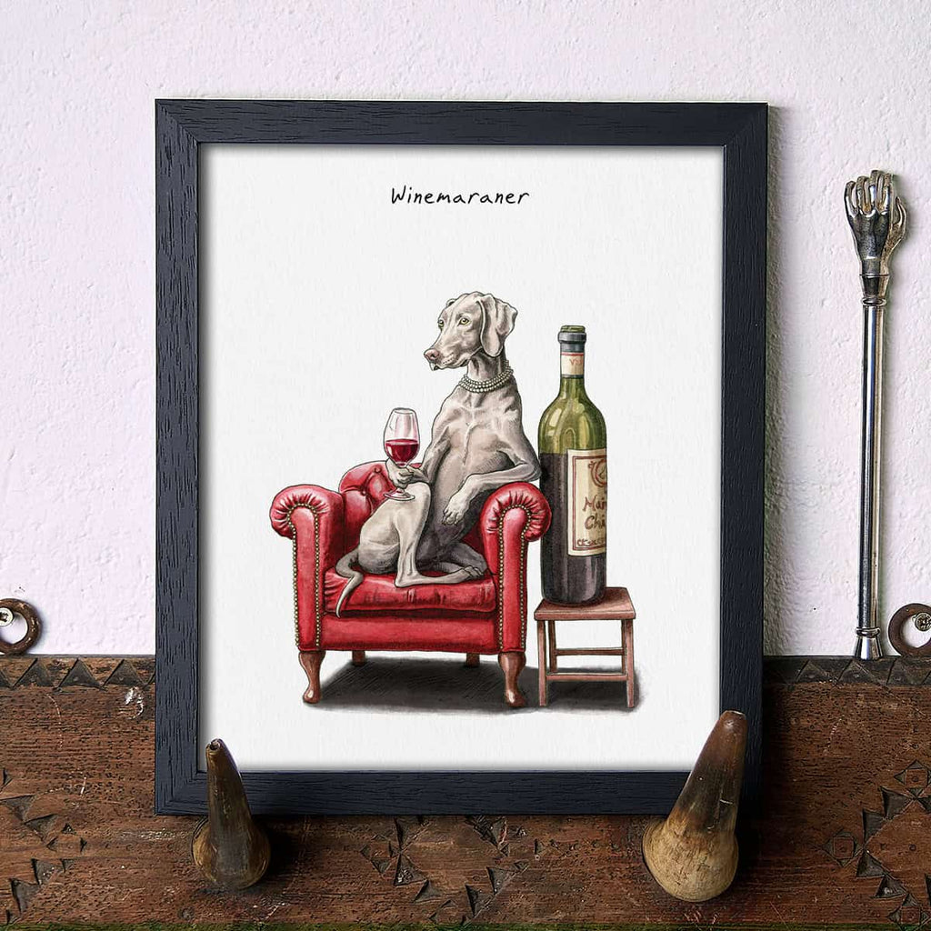 Artwork of a Weimaraner dog on a red armchair with a wine bottle and glass, titled 'Winemaraner'.