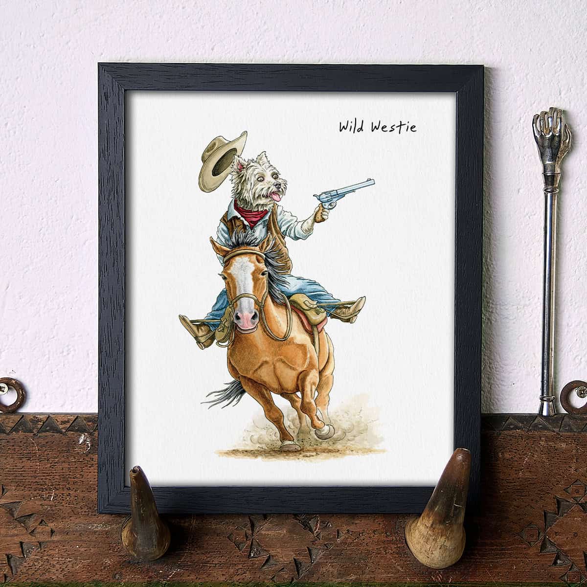 Artwork of a Westie dog dressed as a cowboy on a horse with 'Wild Westie' text.