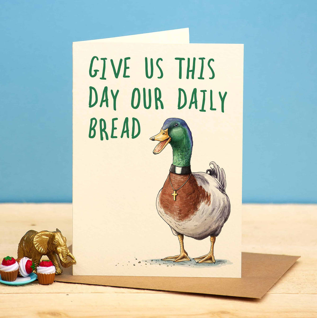 Card with a duck illustration and text 'Give us this day our daily bread' on a blue background.