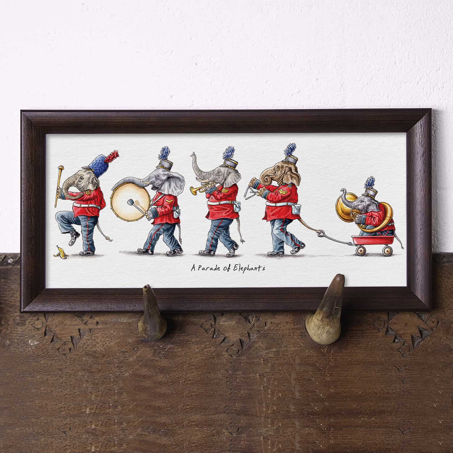 Illustration of a parade of elephants displayed with a wooden frame on a wooden surface.