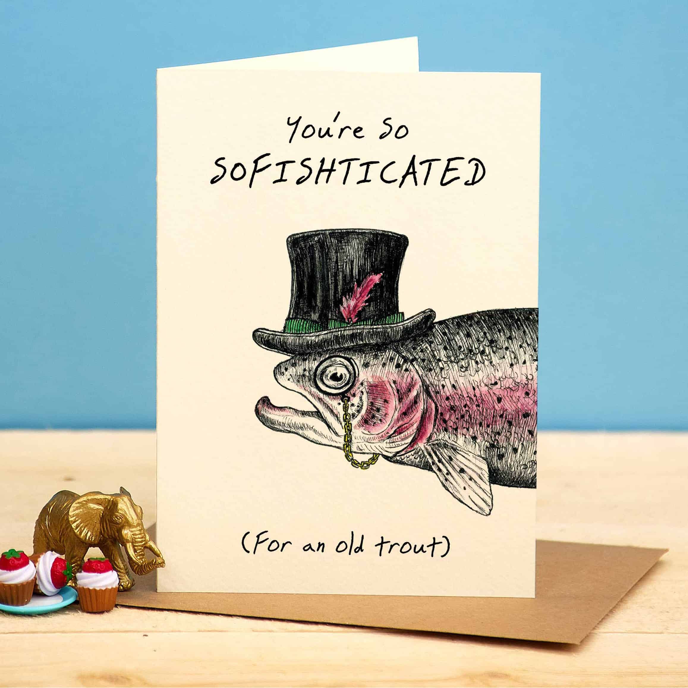 Card with fish wearing a top hat and text 'You're so sofishticated (For an old trout)' on a blue background.
