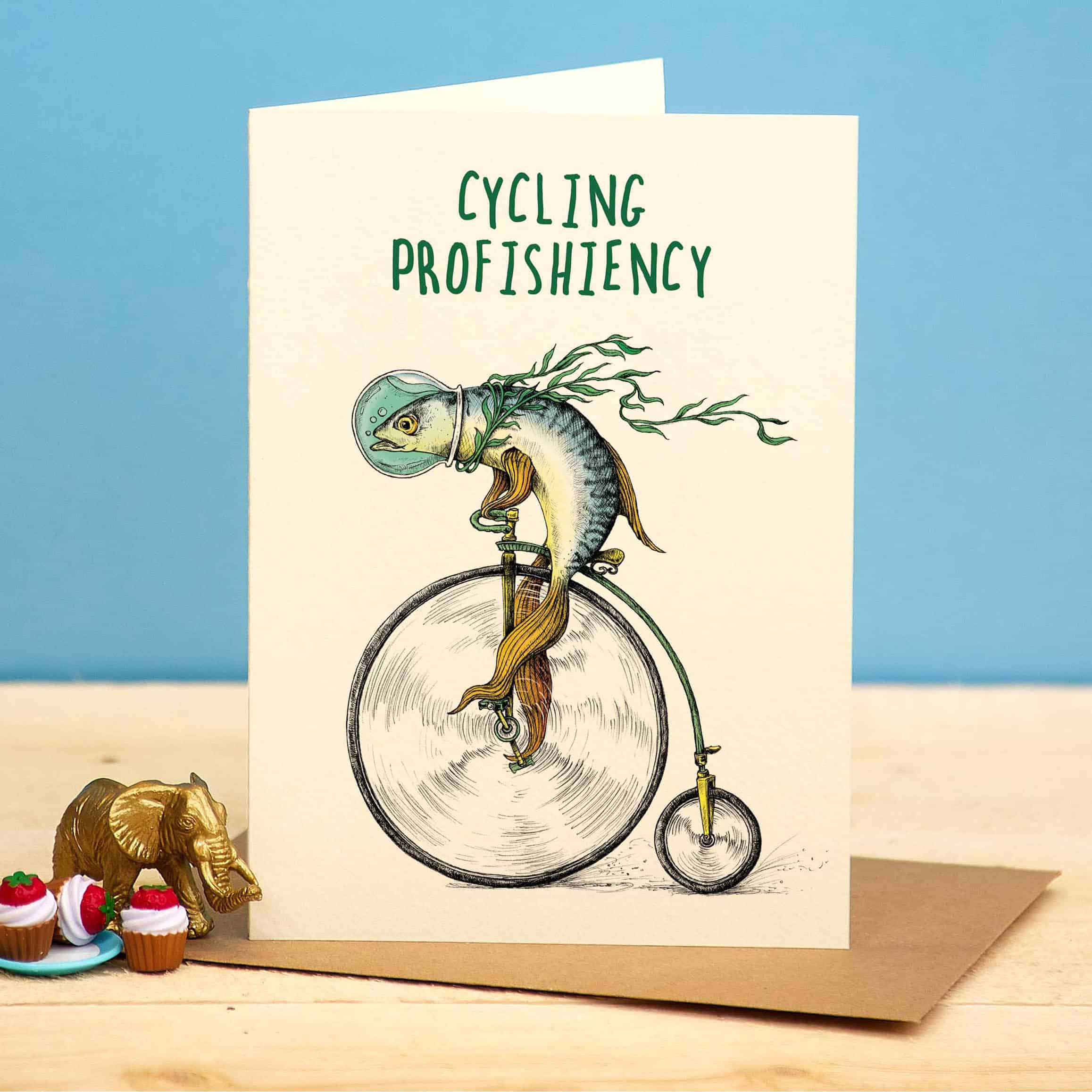 Card with a fish riding a penny-farthing bicycle and text 'Cycling Profishiency' on a blue background.