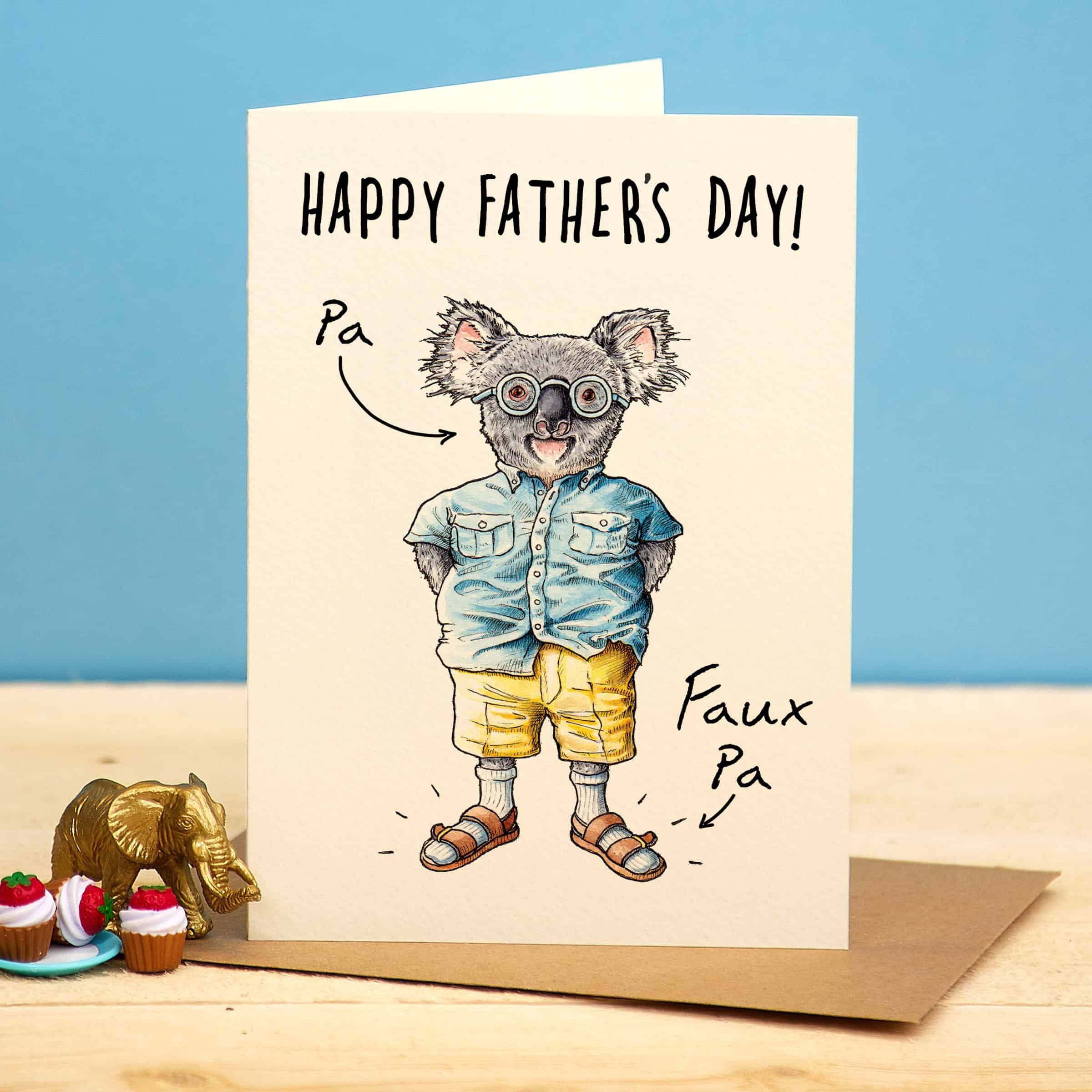 Father's Day card with a cartoon koala wearing sunglasses and a denim shirt on a blue background.