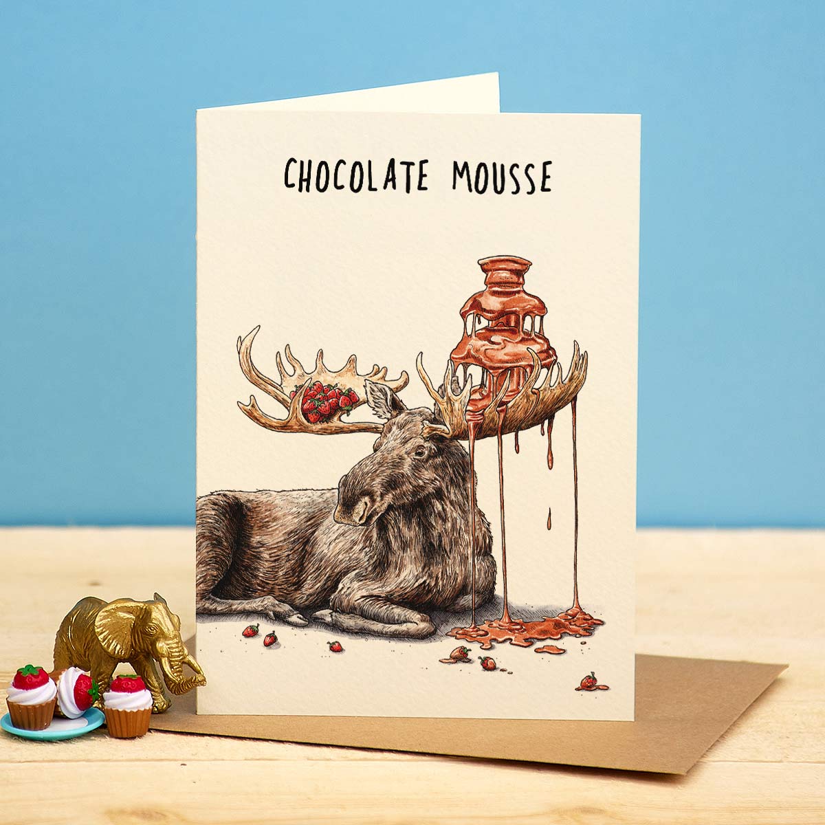 Greeting card with a moose and chocolate fountain illustration on a blue background