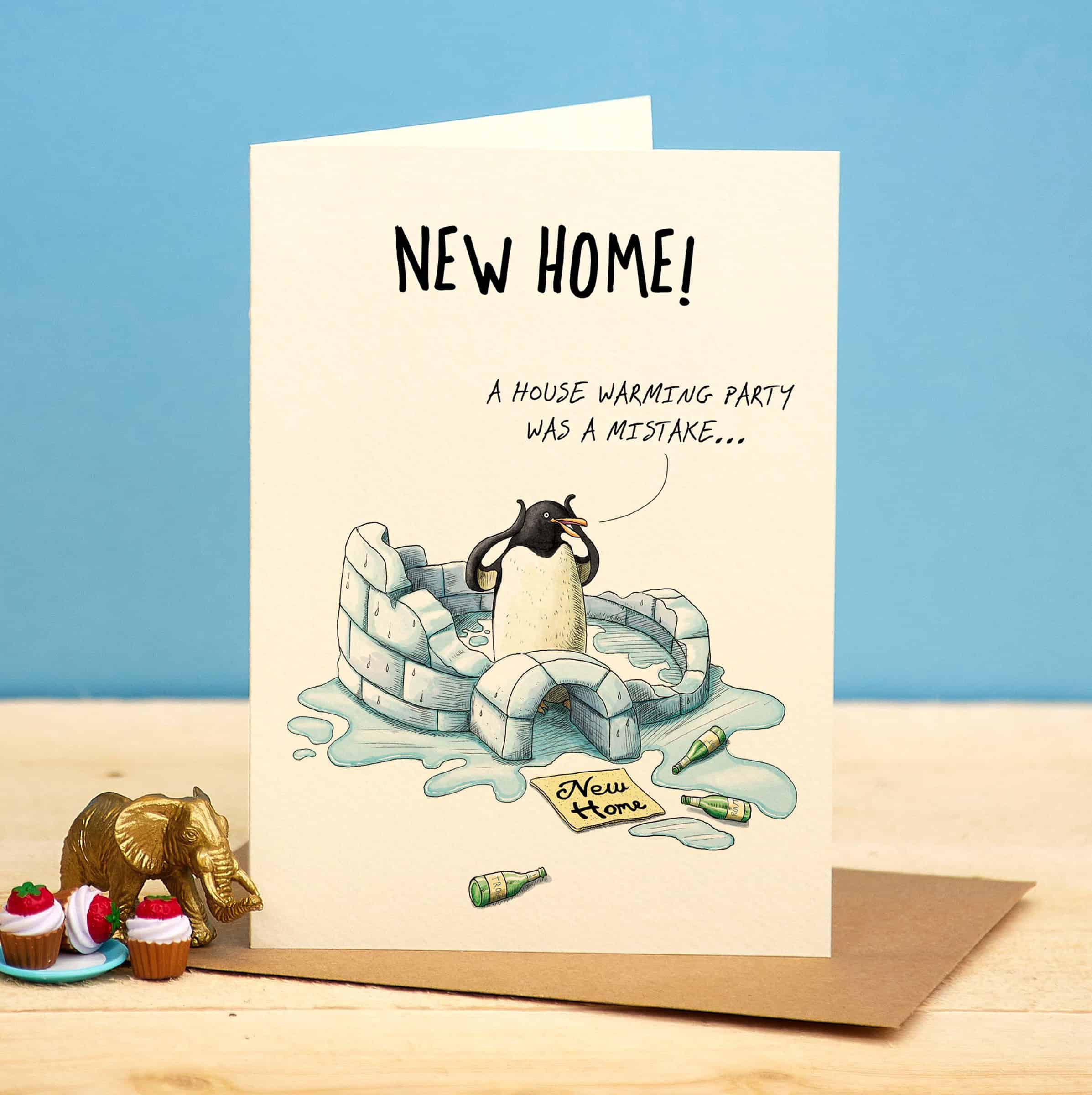 Greeting card with penguin illustration and text about a housewarming party mistake on a blue and beige background.