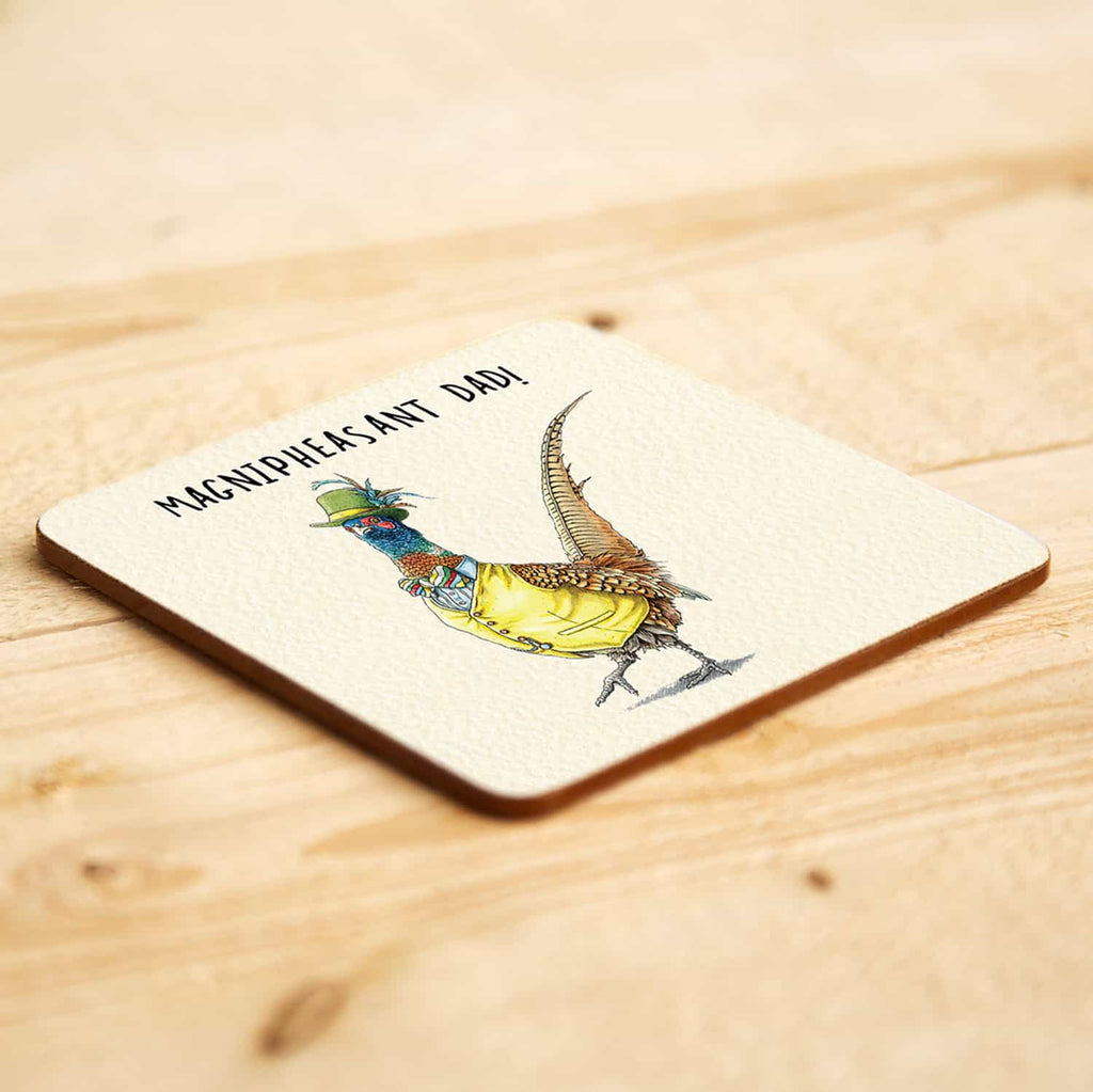 Coaster with a colorful bird illustration and text on a wooden surface