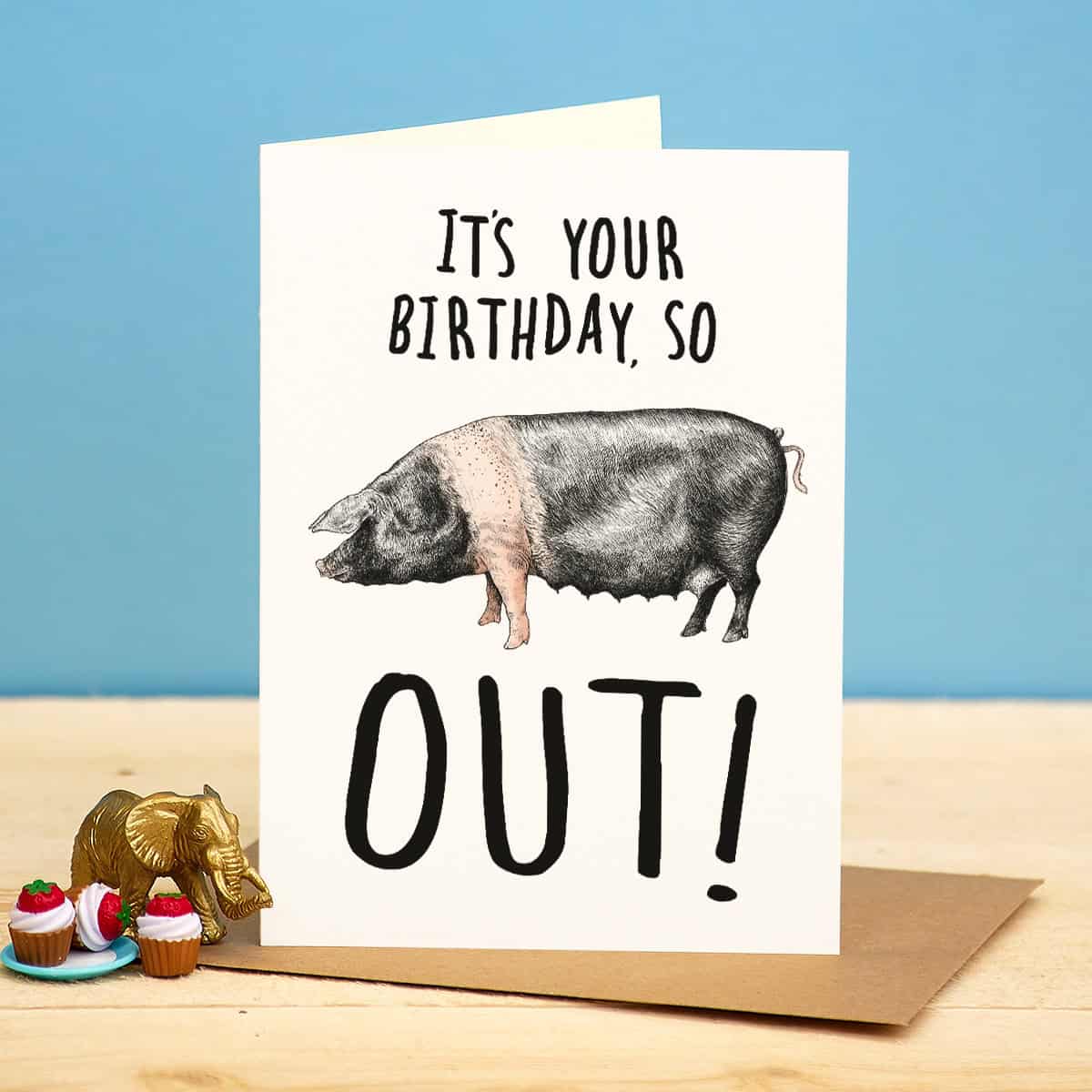 Birthday card with a pig illustration and humorous text on a blue background