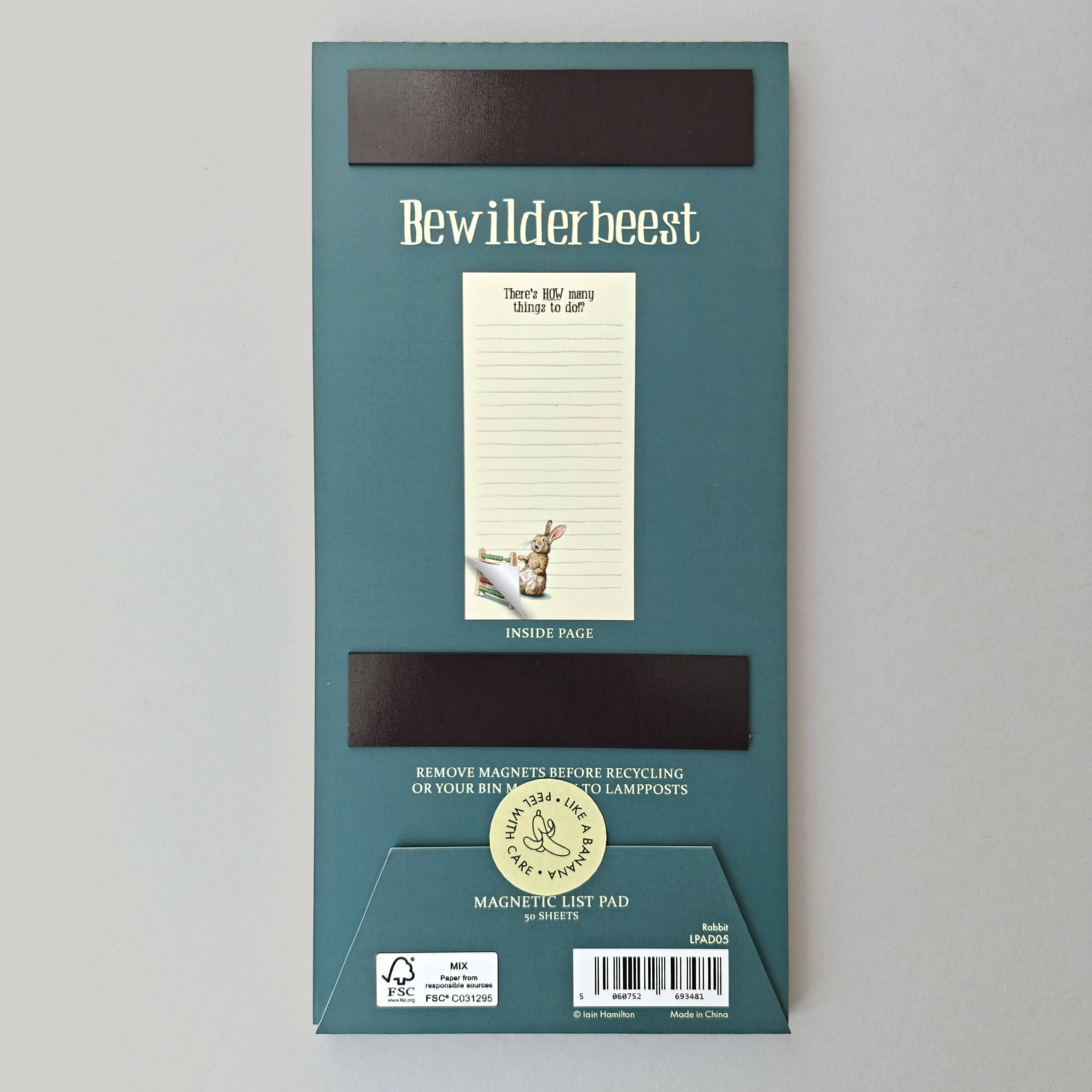 Green packaging of Bewilderbeest magnetic list pad on a gray background