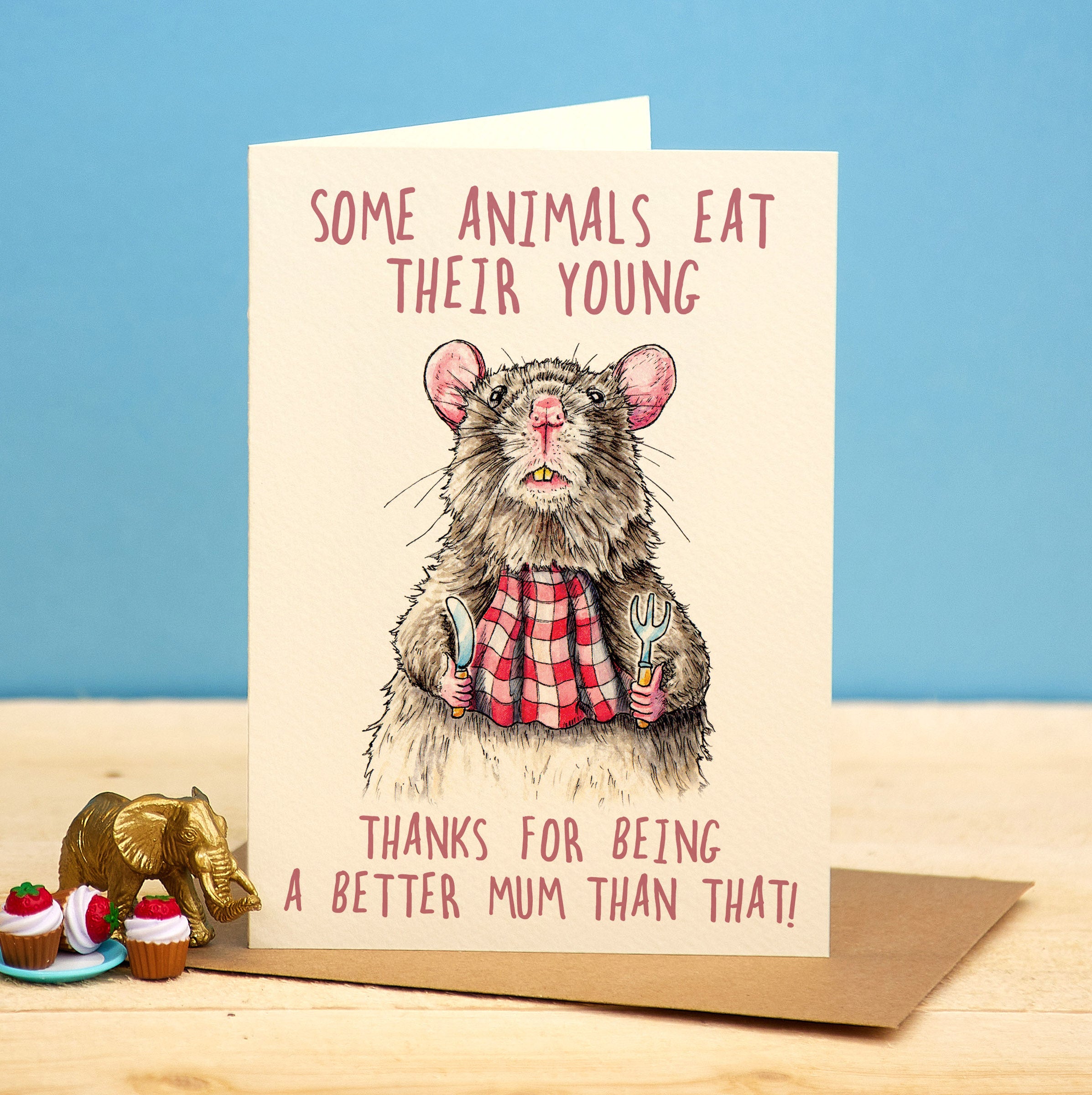 Card with a rat illustration and humorous text on a blue and wooden background