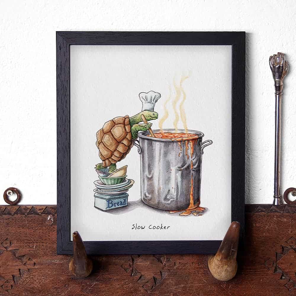 Illustration of a tortoise with a chef hat cooking in a slow cooker on a wooden surface.