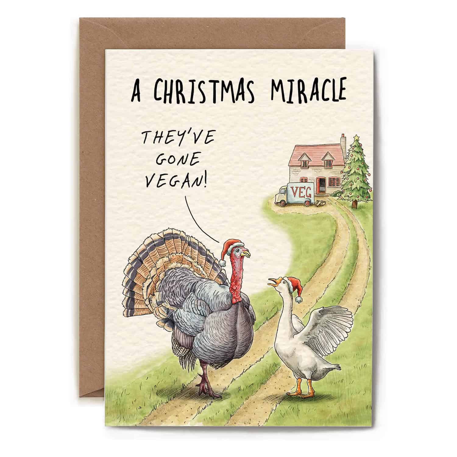 Card with a turkey and goose walking on a path with a house and tree in the background, text 'A Christmas Miracle They've Gone Vegan'.