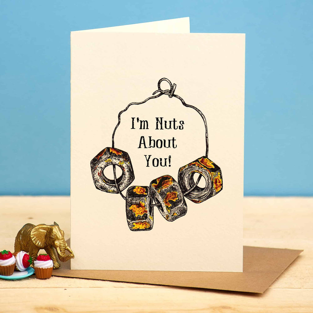 Greeting card with 'I'm Nuts About You!' text and peanut design on a blue background