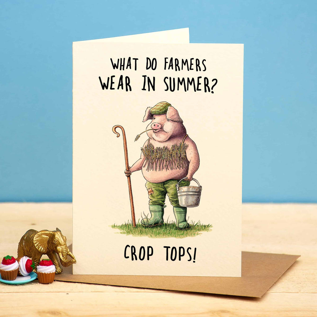 Card with cartoon pig wearing a crop top and shorts, holding a cane and bucket, with text 'What do farmers wear in summer? Crop tops!' on a blue background.