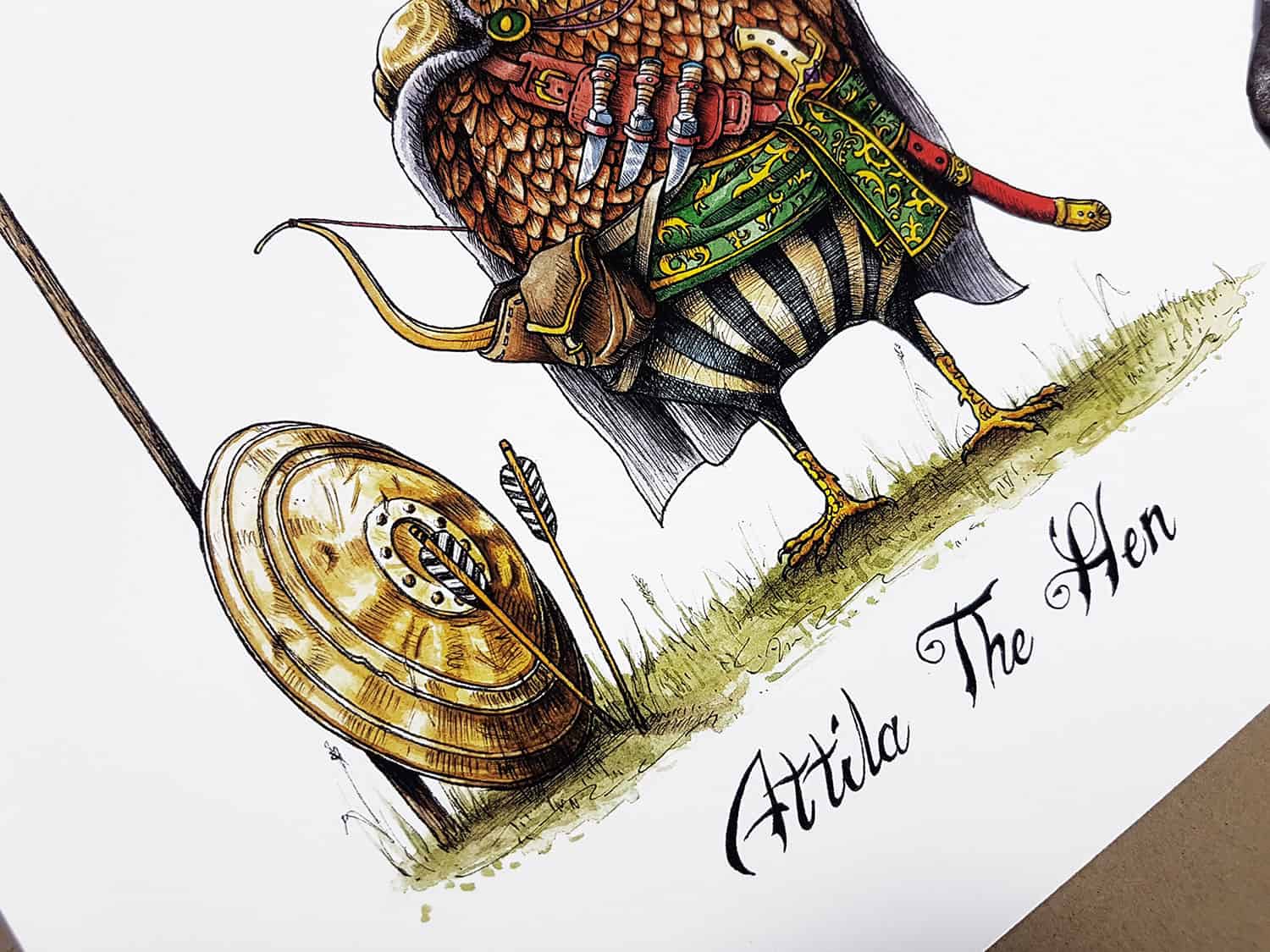 Bottom half of a painting of a chicken wearing a nomadic tribal outfit above text reading “Attila The Hen”