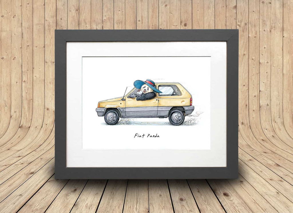 Print of an old yellow fiat panda car being driven by a panda wearing a sunhat in a grey frame on a curved wooden background