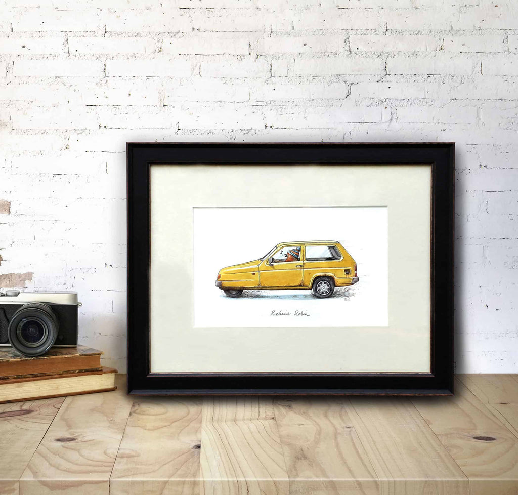 Original illustration of a robin wearing a woolly hat driving a yellow reliant robin car in a black frame on a wooden desk
