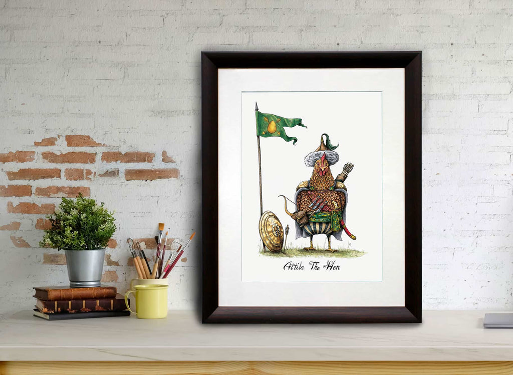 Print of a chicken dressed in a nomadic tribal outfit as Attila The 'Hen' in a dark wood frame leaning against a brick wall