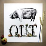 Print of a saddleback pig above bold black lettering decorated with vegetables growing around and beside the letters